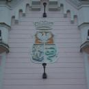 16 Rynek Street in Sanok 2012 tower left north coats of arms Sanok
